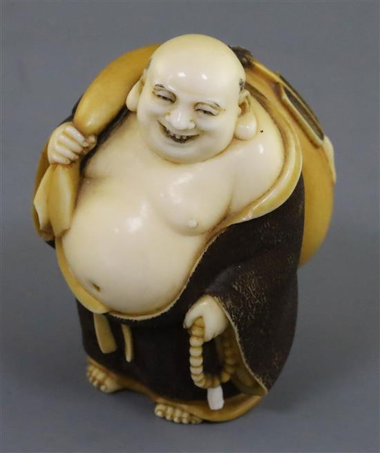 A Japanese ivory okimono netsuke of Hotei, early 20th century, H. 5.2cm